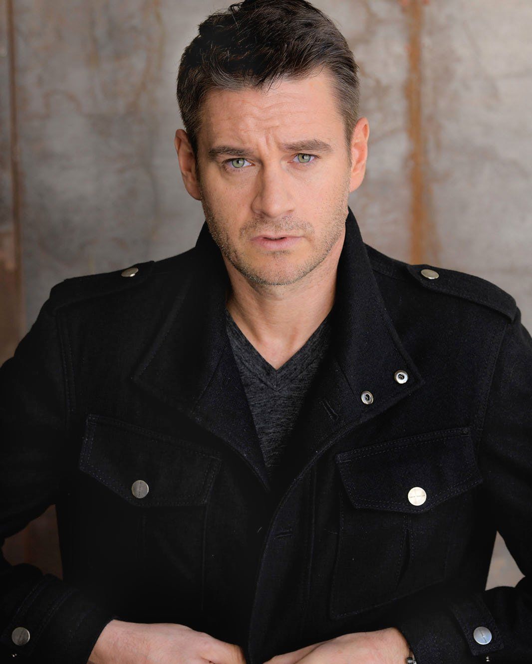 Clark Moore — headshot, dark jacket, city backdrop